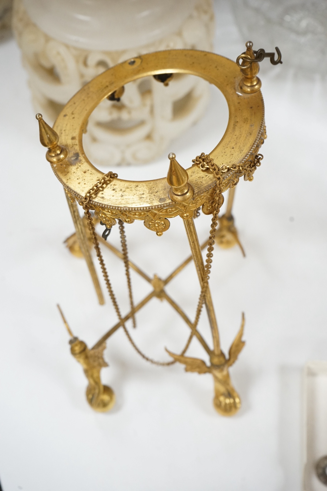 An unusual enamel and gilt brass timepiece, pendant from gilt brass frame, stand 26cm high. Condition - dismantled
